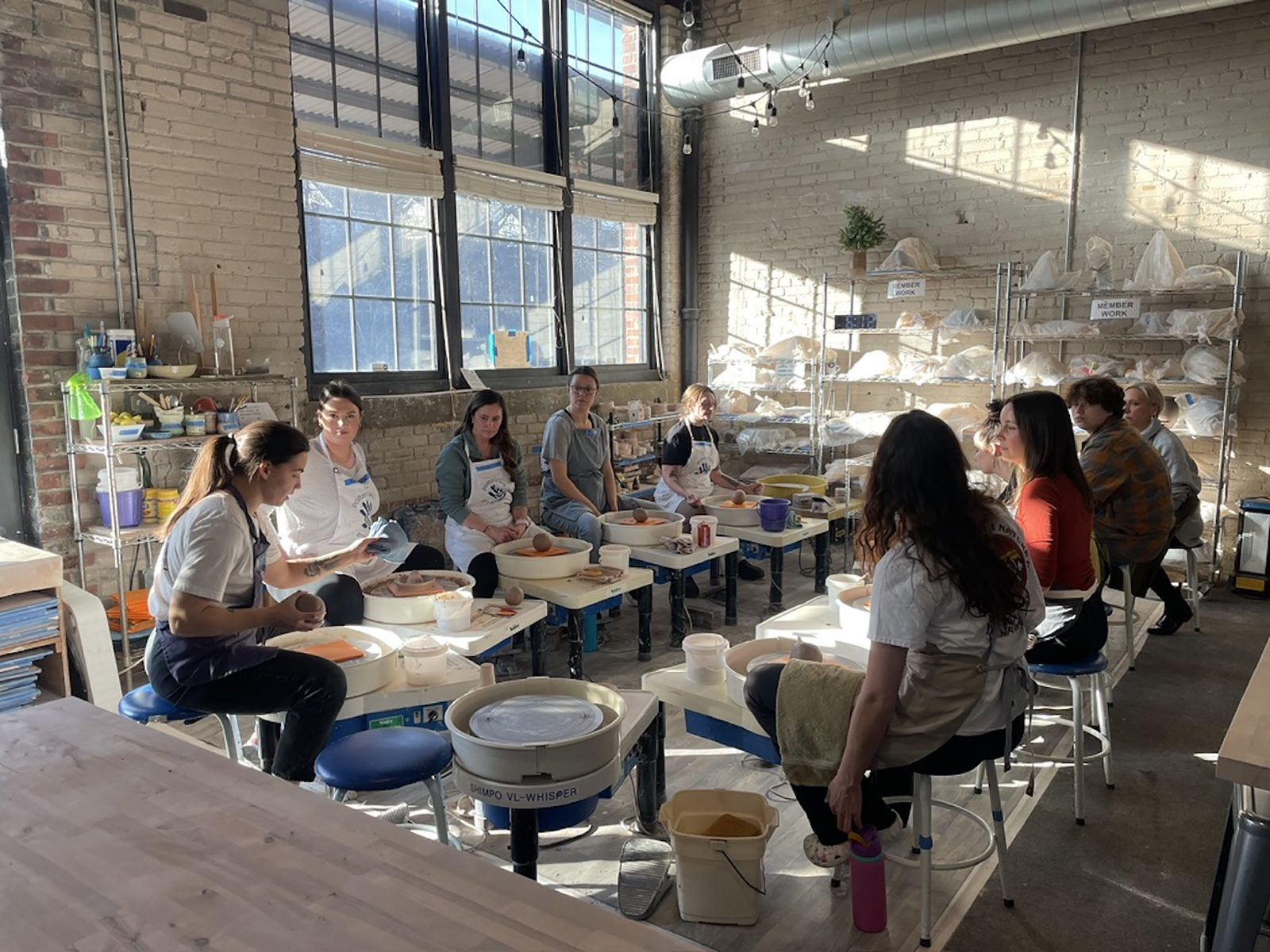 Woman at wheel making a large pot