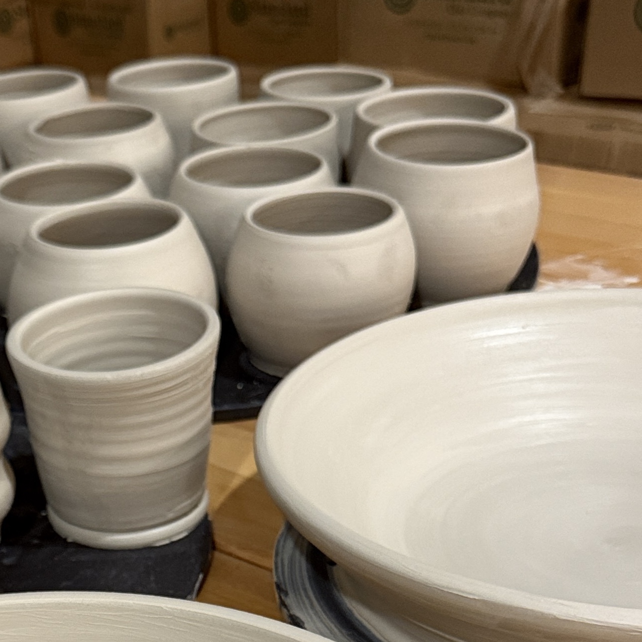 Girl spinning clay on pottery wheel